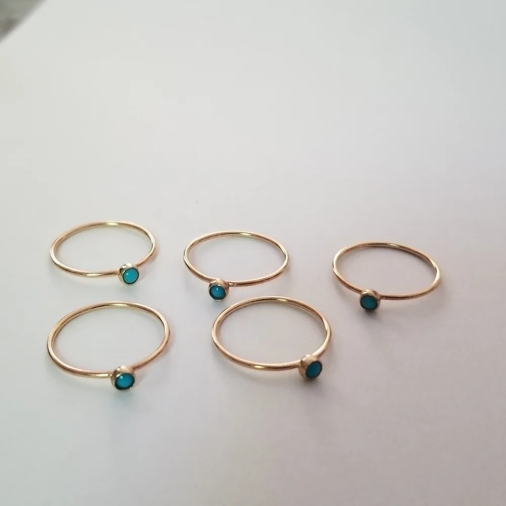 set of 5 gold tone stacking rings with small blue cabochon size 5.25